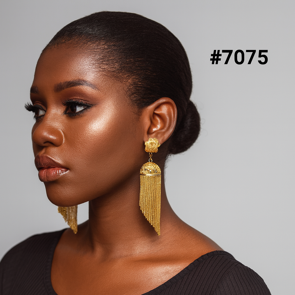Elegant Black woman in profile with a sleek bun, glowing makeup, black top, and ornate gold tassel earrings; gray background labeled #7075.