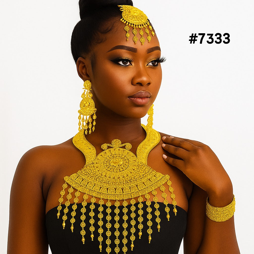 Portrait of a poised Black woman in a black dress wearing ornate gold jewelry, earrings, necklace, headpiece, and bracelets; #7333.