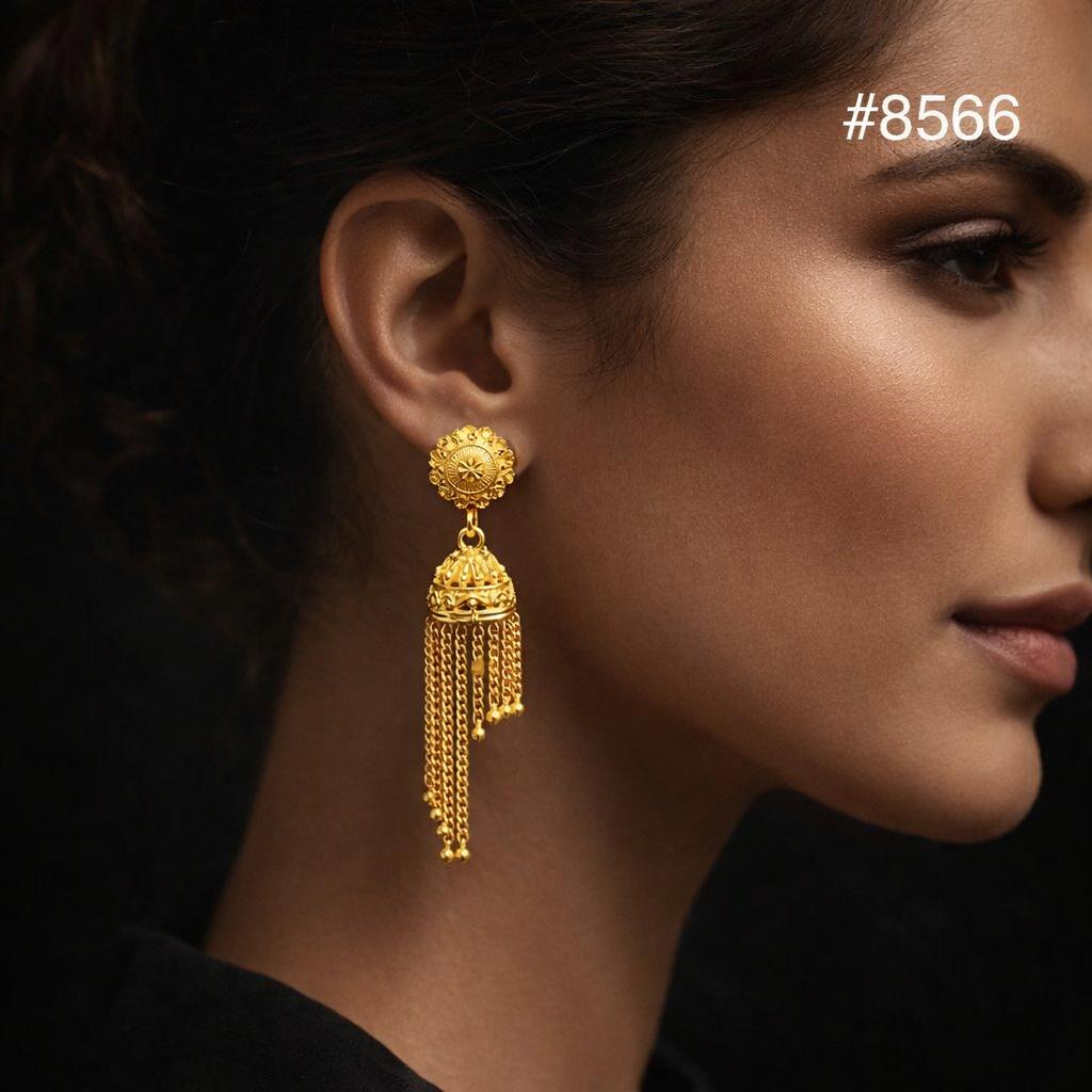 Close-up side profile of a woman wearing an ornate gold jhumka earring with dangling chains, set against a dark background; elegant, refined mood.