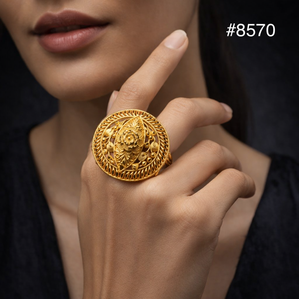 Close-up of a woman wearing an ornate gold statement ring with floral detailing, posed against black fabric; elegant, luxurious mood. #8570