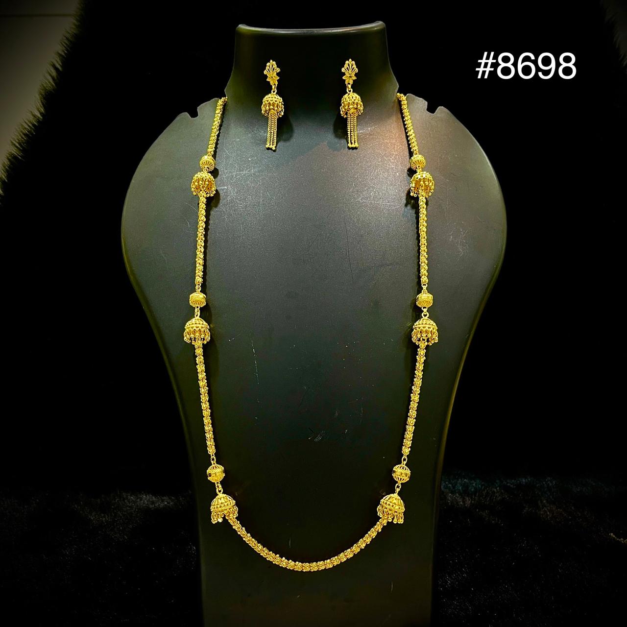 Gold necklace with ornate pendants and matching dangling earrings on a black mannequin bust, creating an elegant jewelry display; item #8698.