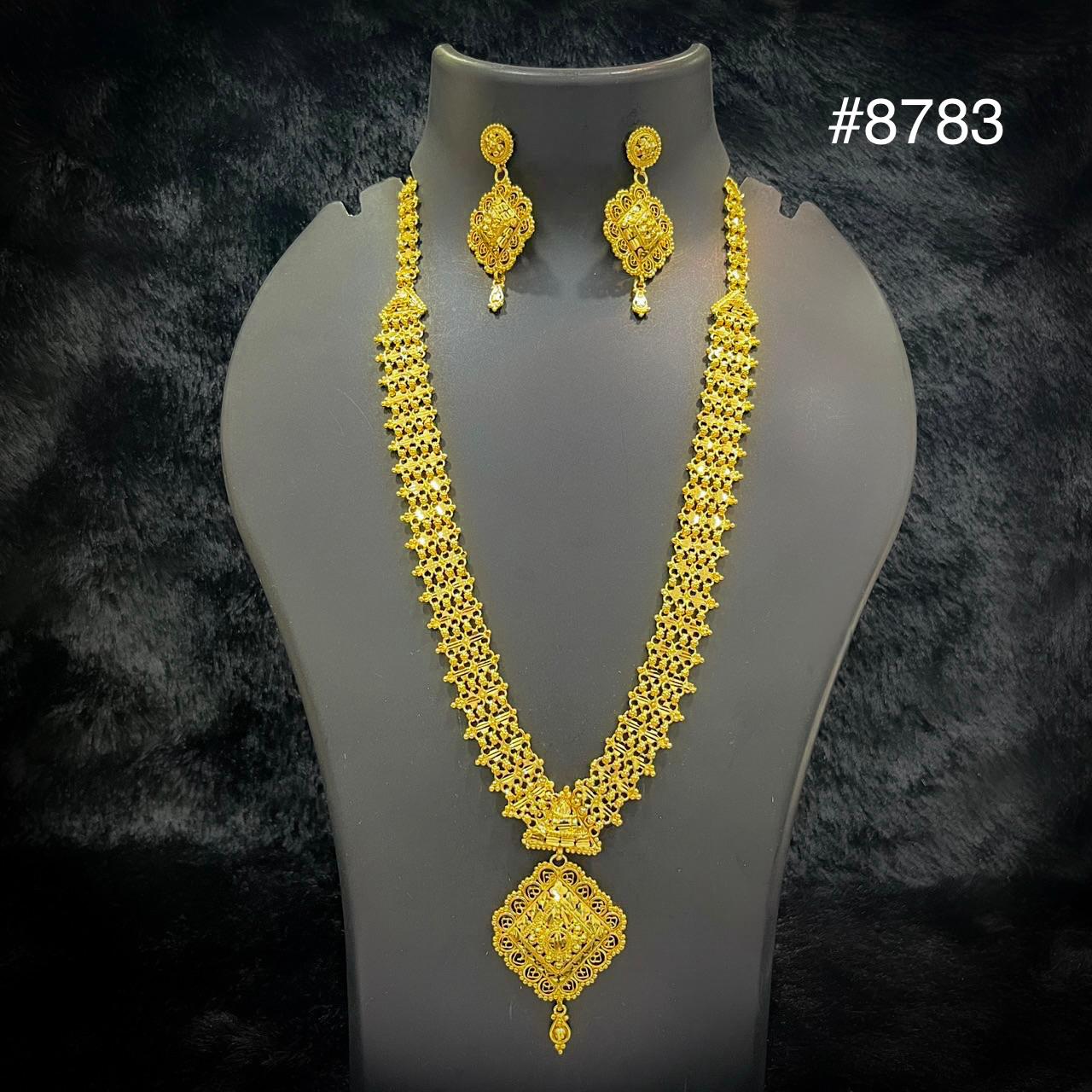 Gold necklace and earring set with intricate design displayed on a black stand, labeled with the number 8783 in the top right corner.