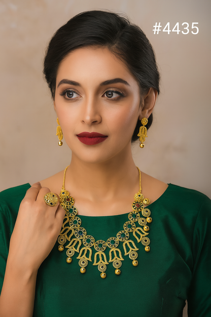 A gold necklace with intricate filigree design and matching earrings displayed on a black bust. The set features circular and teardrop patterns with dangling gold beads. The number #8749 is shown in the top right corner.