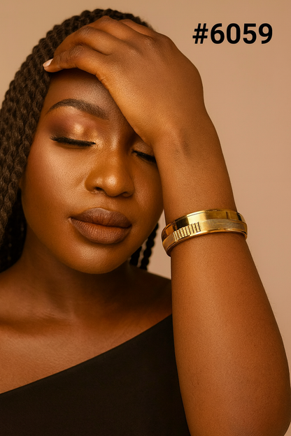 Close-up portrait of a Black woman with braided hair, eyes closed and hand resting on her forehead, wearing gold bracelets and a black top; serene mood.