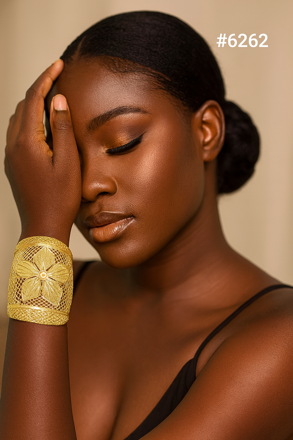Close-up portrait of a serene Black woman with eyes closed, hand resting on her face, wearing a gold floral cuff and black top; #2626.