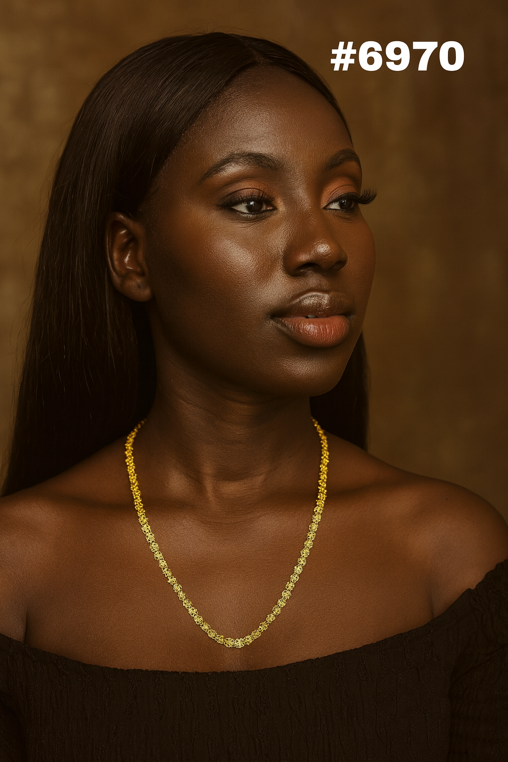 Portrait of a Black woman with long dark hair, wearing a delicate gold necklace and black off-shoulder top, gazing calmly right in warm light.