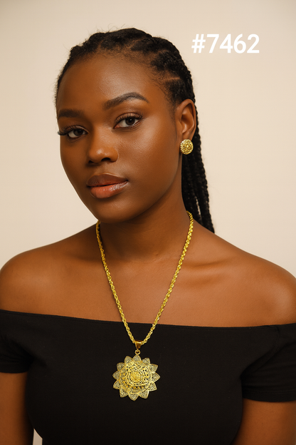 Portrait of a confident Black woman with braided hair, gold earrings and ornate necklace, wearing a black off-shoulder top; #7462.