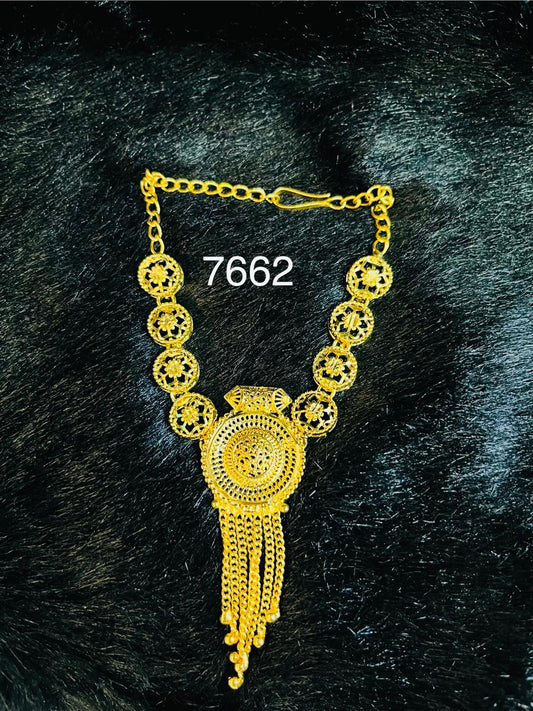 Ornate gold necklace with circular filigree links and a large medallion with dangling chains, displayed on black textured fabric beside the number 7662; a luxurious tone.