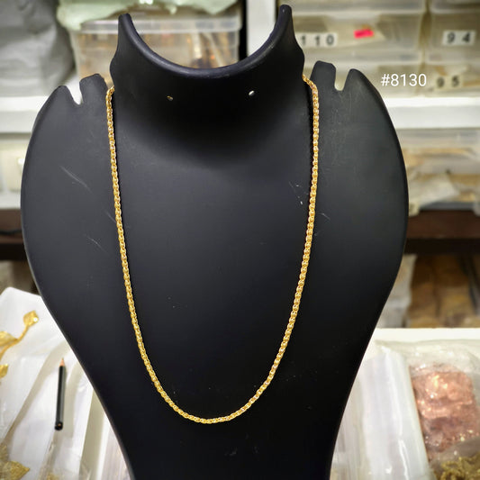 Gold chain on a black mannequin bust with a blurred background