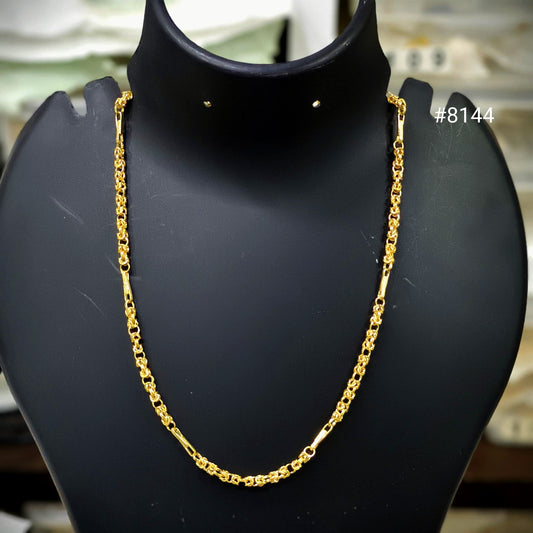 Gold chain necklace on a black mannequin bust with a blurred background.