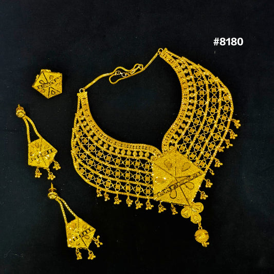 Gold necklace and earrings set on a black background