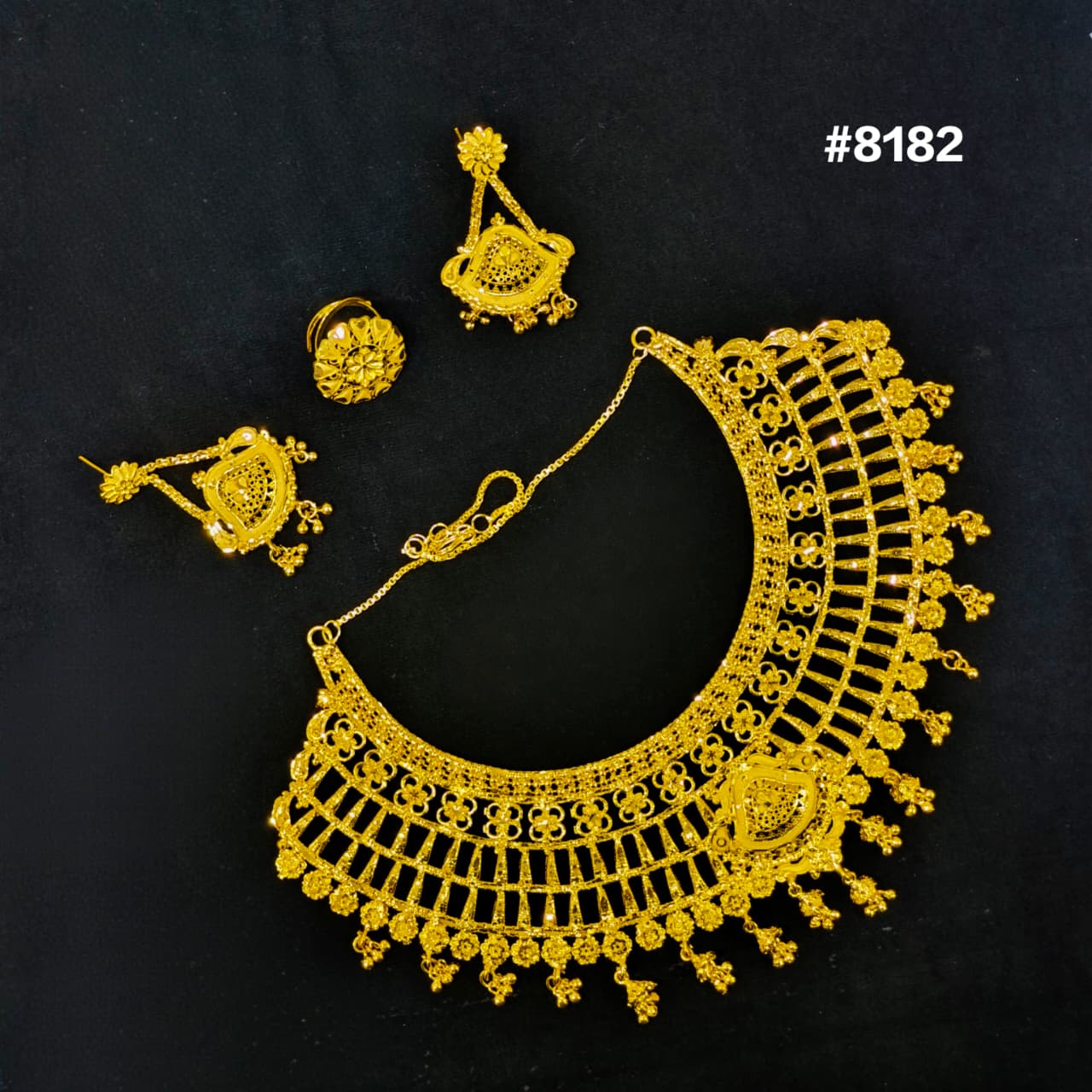 Gold necklace and earrings set on a black background with product number #8182.