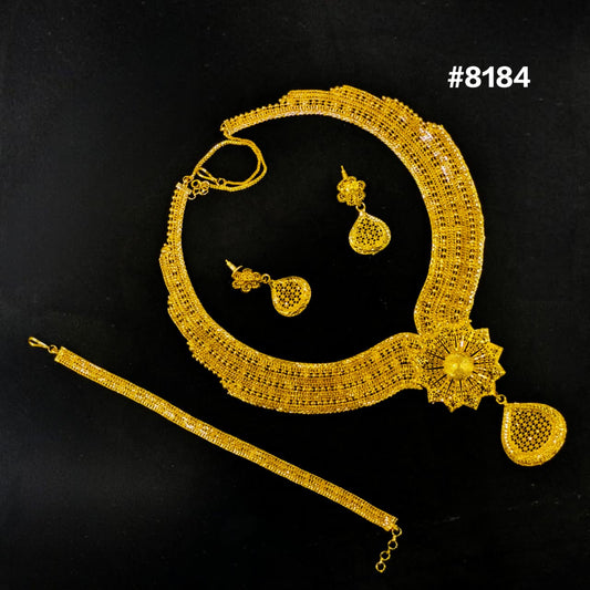 Gold necklace set with matching earrings on a black background