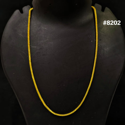 Gold chain on a black mannequin with '#8202' text.