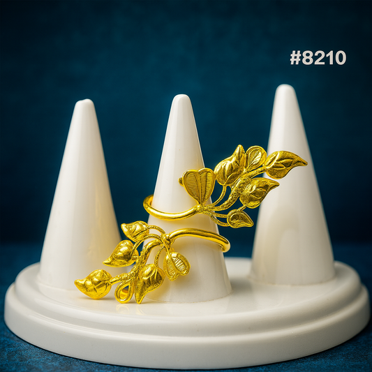 Gold brooch on a white stand against a blue background