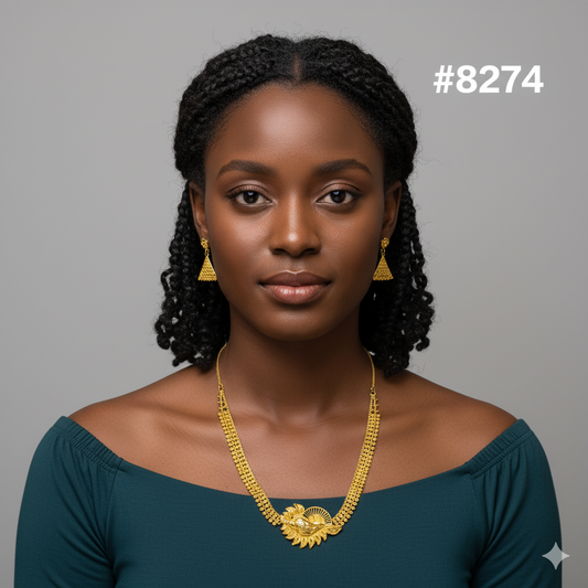 Woman wearing a gold necklace and earrings against a gray background