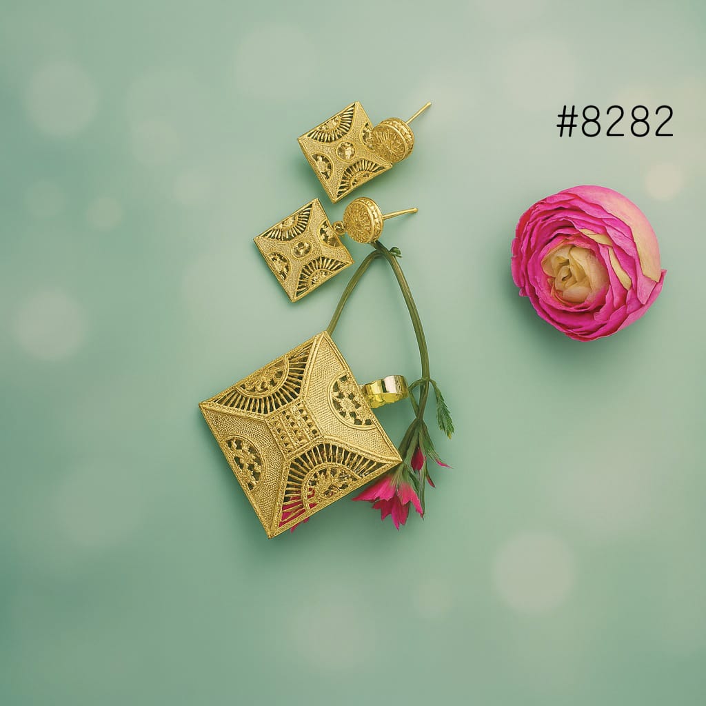 Gold earrings with floral accents on a green background
