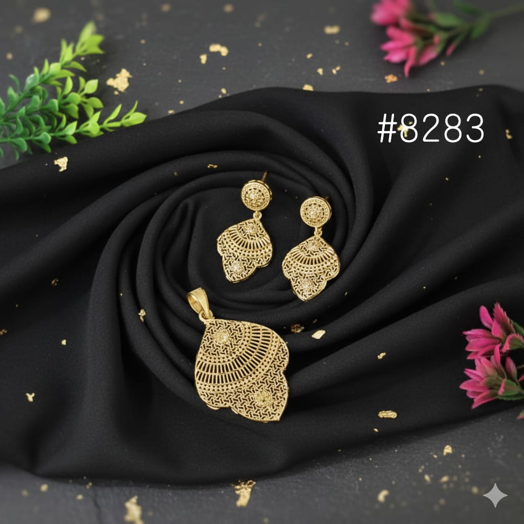 Gold jewelry set on black fabric with decorative elements