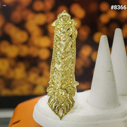 Gold decorative item on a white stand with a blurred background