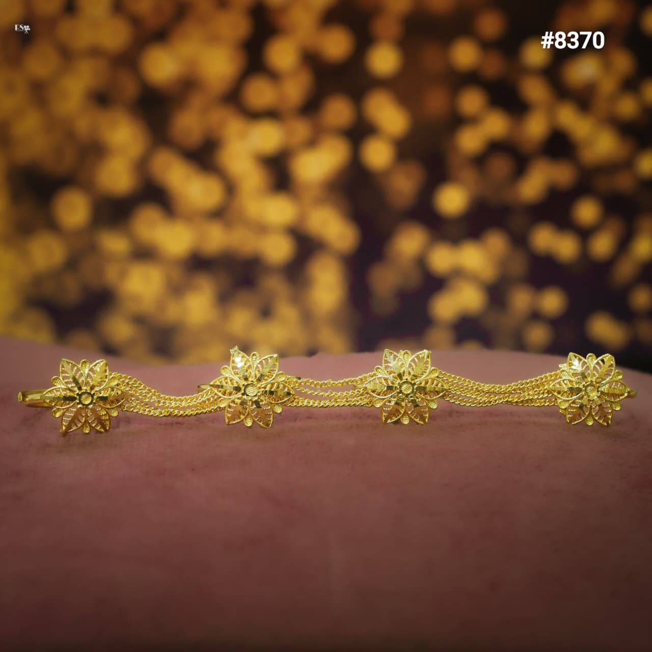 Gold Finger Ring with floral designs on a blurred gold background