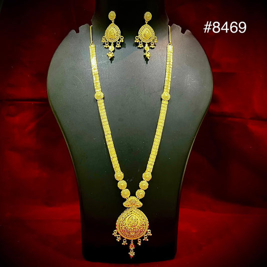Gold necklace and matching ornate earrings on a black mannequin against red velvet, featuring a detailed pendant; elegant jewelry set #8469.