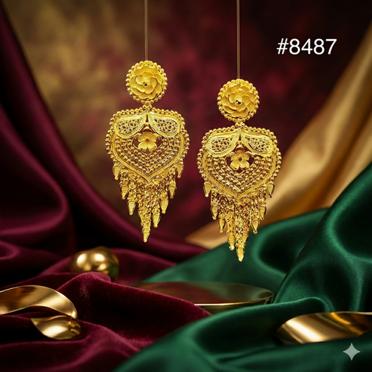 Gold earrings on a luxurious fabric background with a visible brand number.