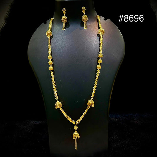 Gold necklace and matching drop earrings with ornate traditional detailing displayed on a black mannequin against a dark background; elegant jewelry set #8696.