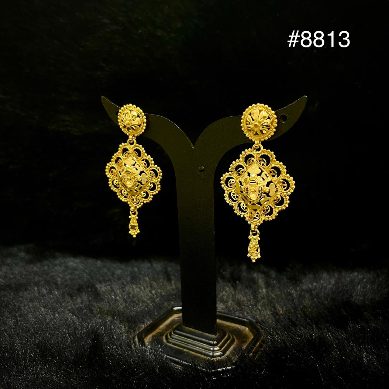 A pair of ornate gold earrings with floral and filigree designs are displayed on a black stand against a dark background. The number #8813 is shown in the top right corner.