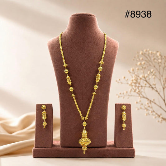 Gold beaded necklace with an ornate pendant on a brown velvet bust, matching earrings displayed beside it; elegant jewelry set #8938.