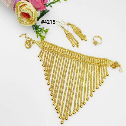 Ornate gold bridal jewelry set with a cascading chain necklace, matching earrings and ring, displayed beside pink and yellow flowers on white.