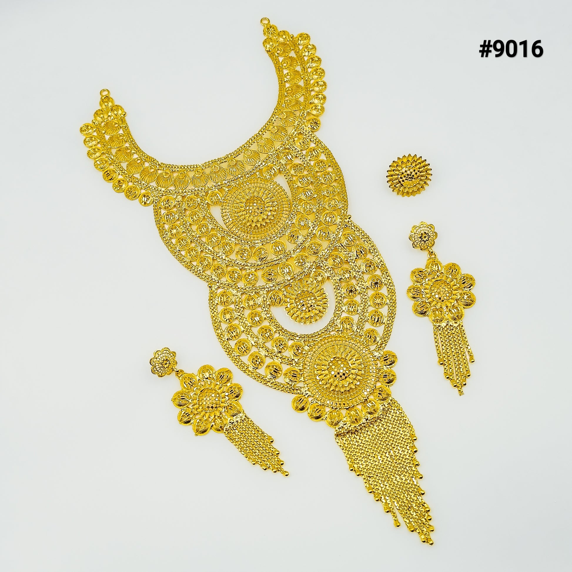 Ornate gold jewelry set featuring a large crescent-shaped necklace with intricate filigree, matching dangling earrings, and a floral pendant, labeled #9016. 2