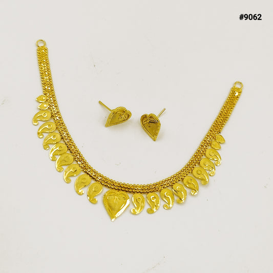 Gold necklace and matching earrings displayed on a white background, featuring ornate textured chains and dangling heart-shaped charms; elegant jewelry set.