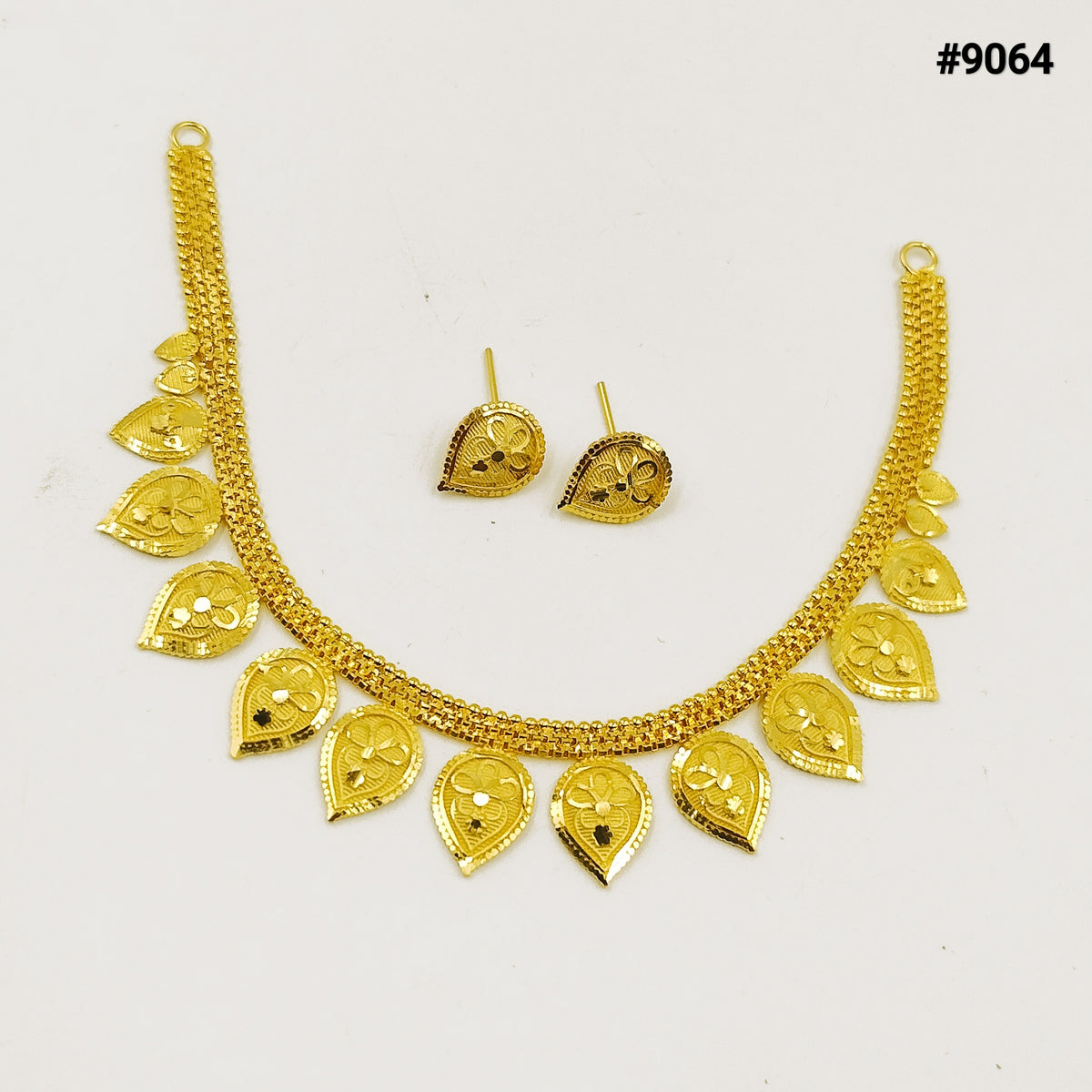 Gold necklace and matching earrings with ornate teardrop charms and floral details, arranged on a white background; elegant jewelry set, #9064.